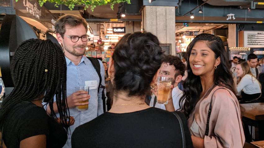 people talking in circle at networking event